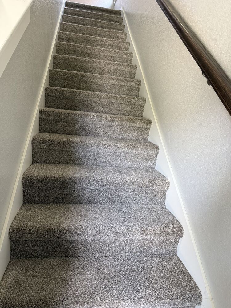 Gray plush carpet installed on a staircase