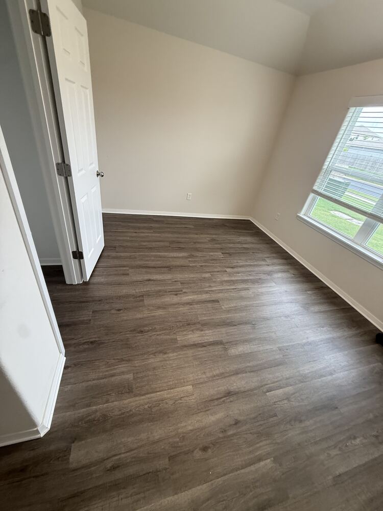 Dark wood-look vinyl plank flooring in a bedroom